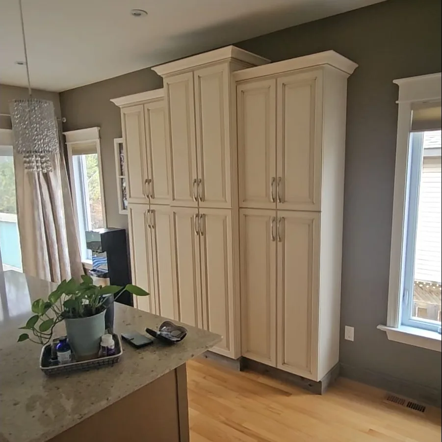 Before: Pantry Cabinets & Island: Cream pantry cabinets and dark grey walls before refinishing