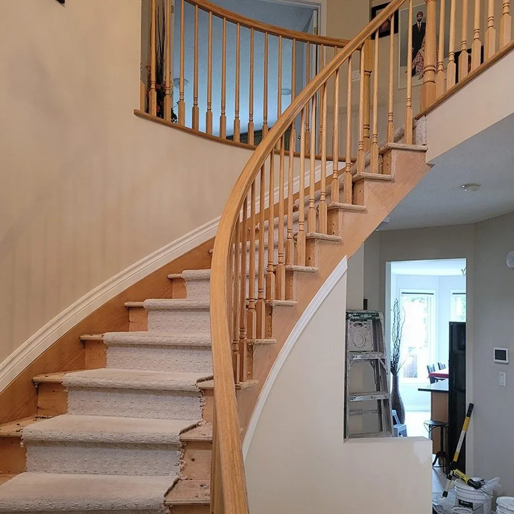 Ottawa staircase before refinishing - original light wood railing and worn carpet