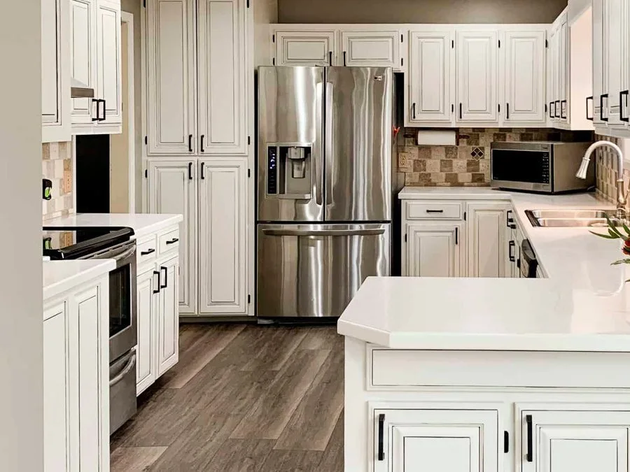 Ottawa kitchen after cabinet refinishing - white cabinets with black hardware transformation